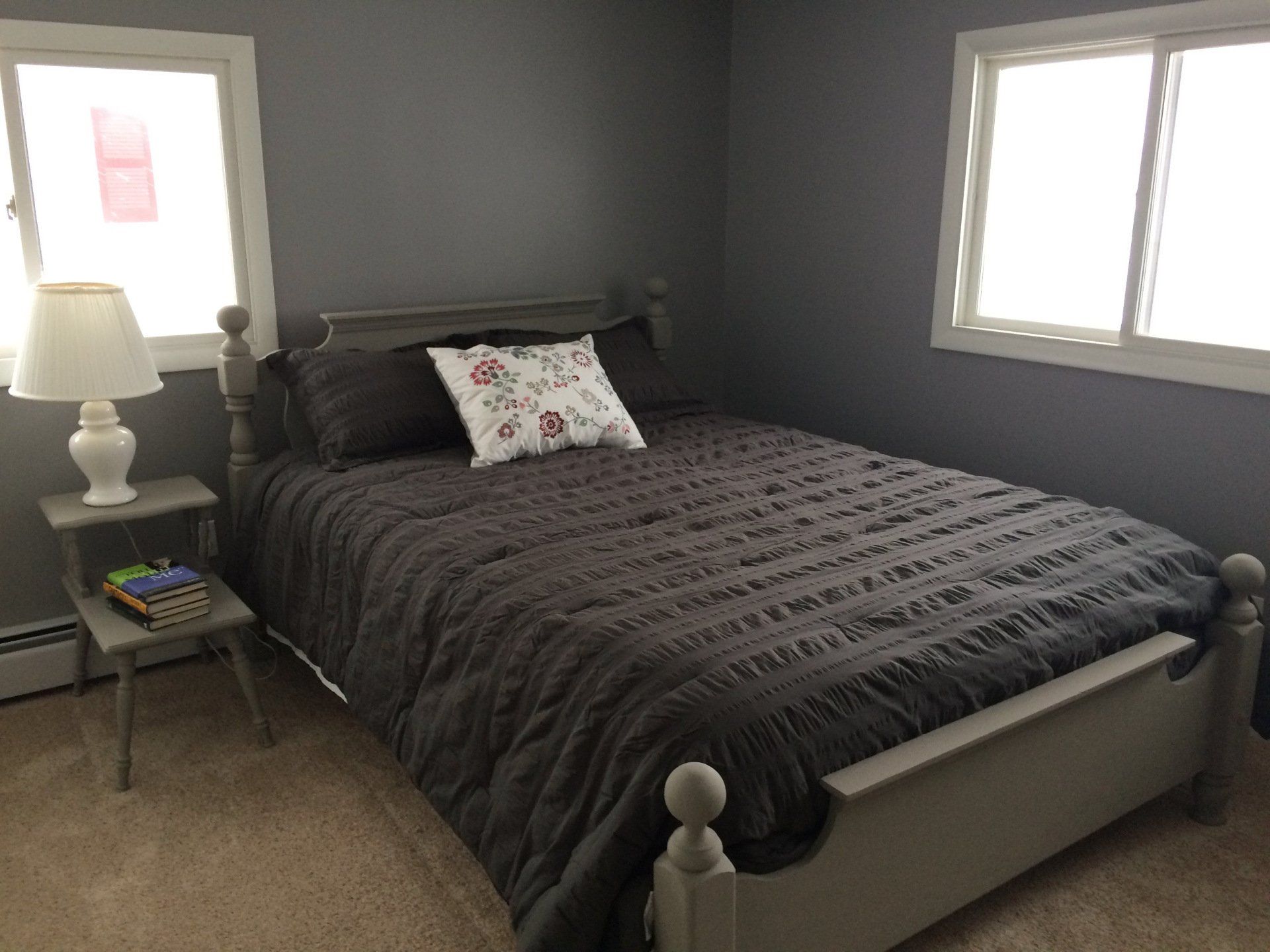 A bedroom with a bed and a lamp in it