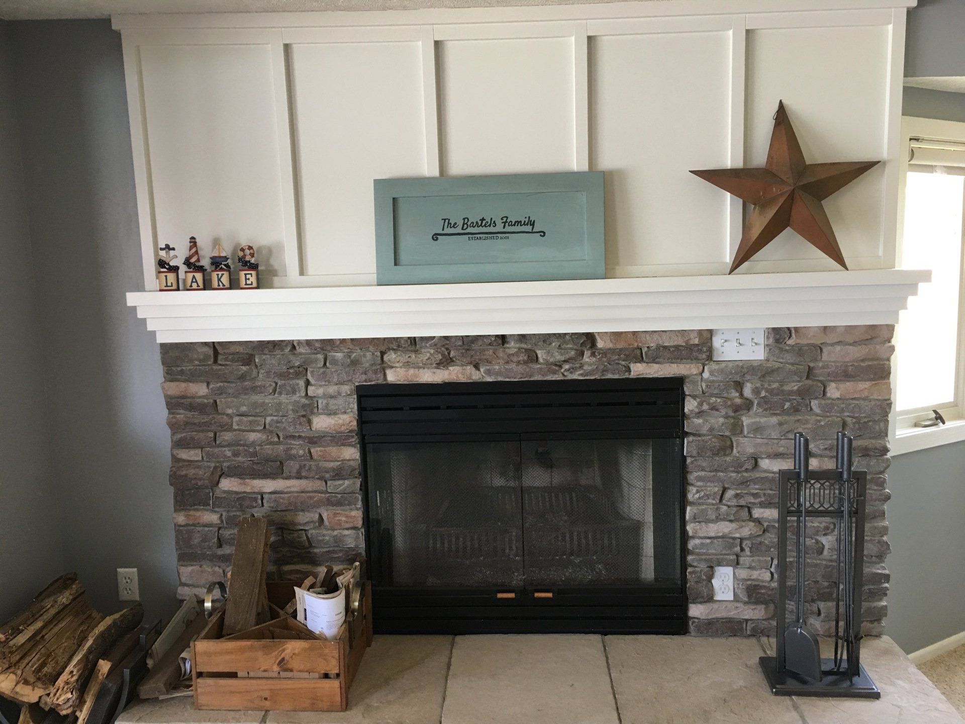 A living room with a fireplace and a star on the mantle.
