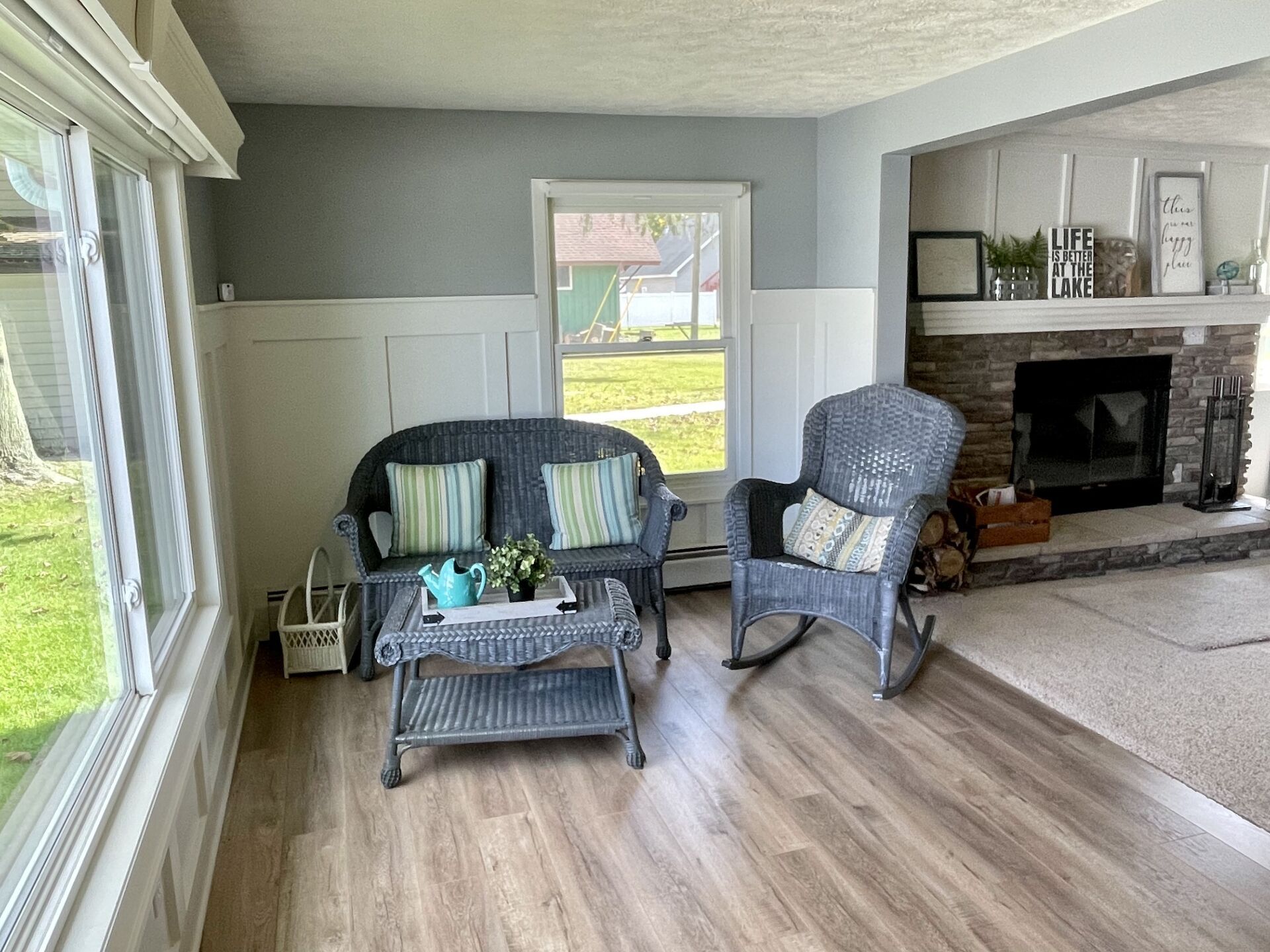 A living room with a couch, two rocking chairs, a coffee table, and a fireplace.