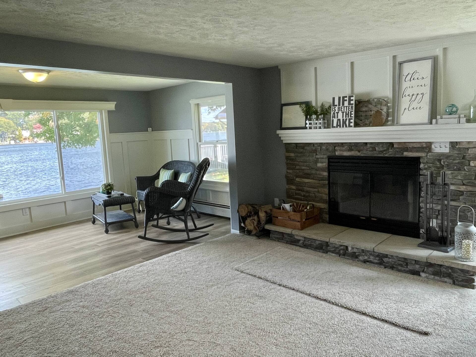 A living room with a rocking chair and a fireplace.