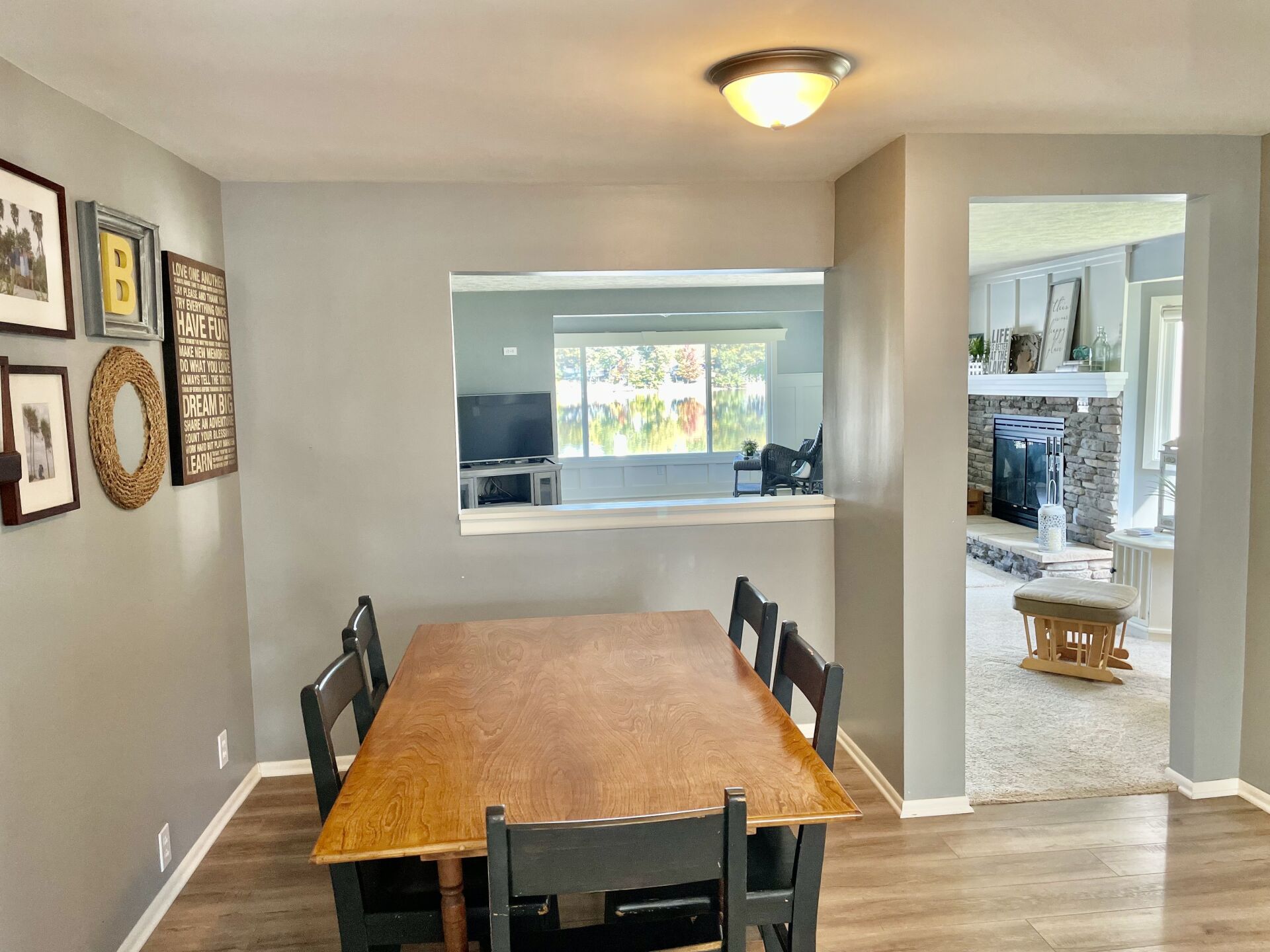 A dining room with a table and chairs and a window.