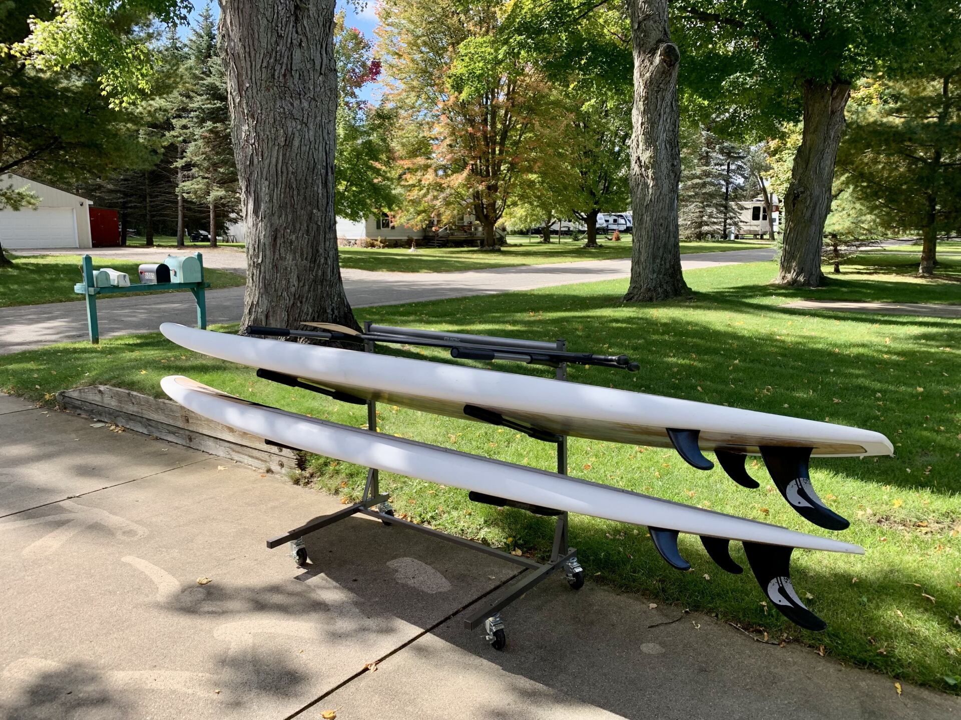 Two surfboards are stacked on top of each other on a rack.