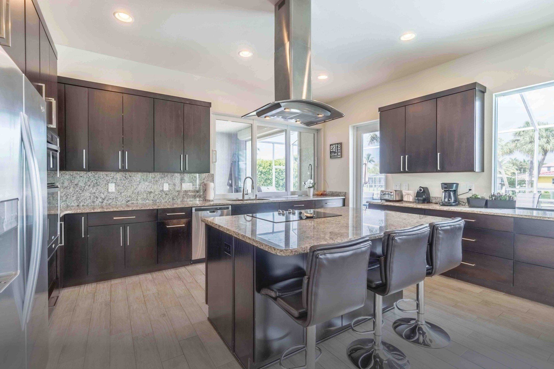 A large kitchen with stainless steel appliances and a large island.