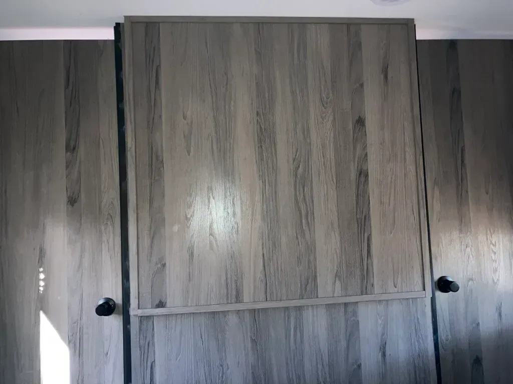 A close up of a wooden door in a room.