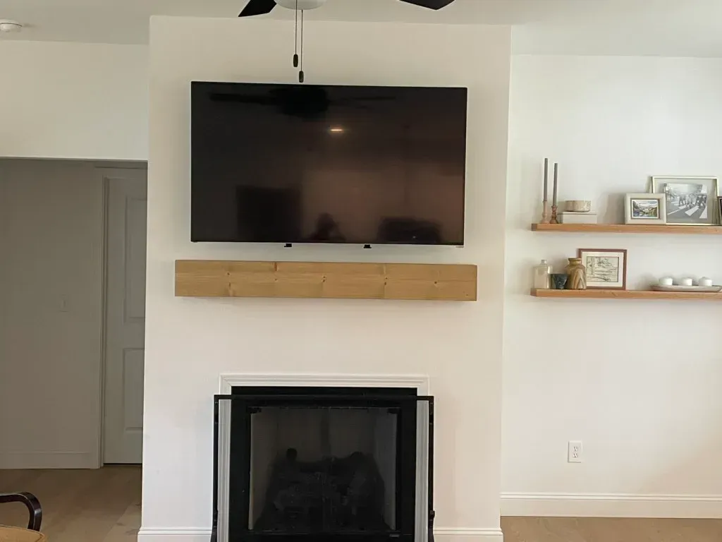 A living room with a fireplace and a flat screen tv