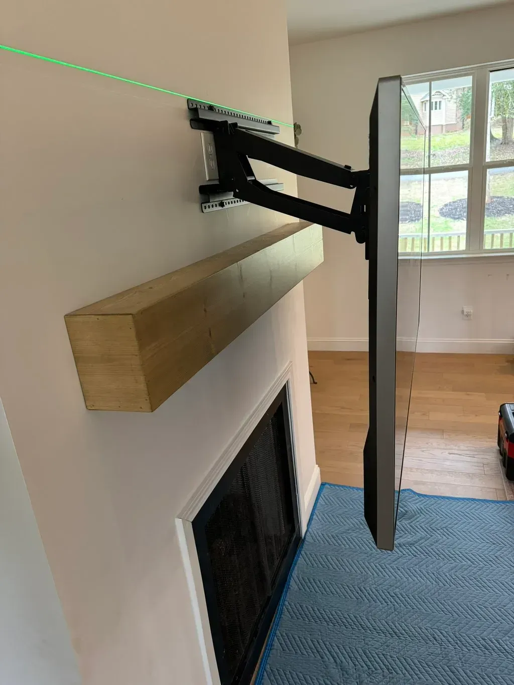 A flat screen tv mounted to a wall next to a fireplace.