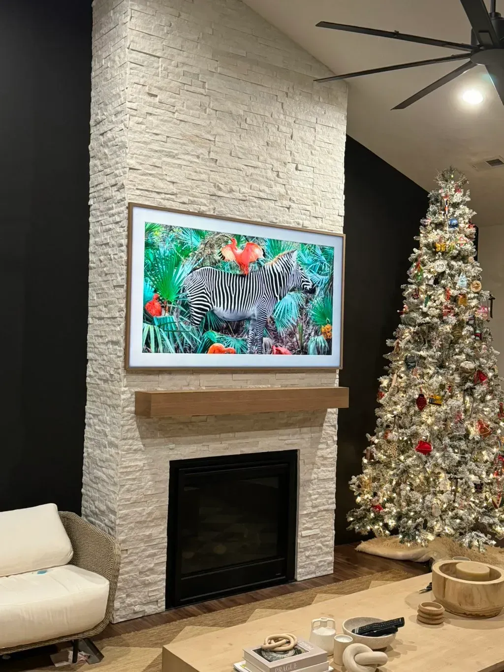 A living room with a fireplace and a christmas tree.