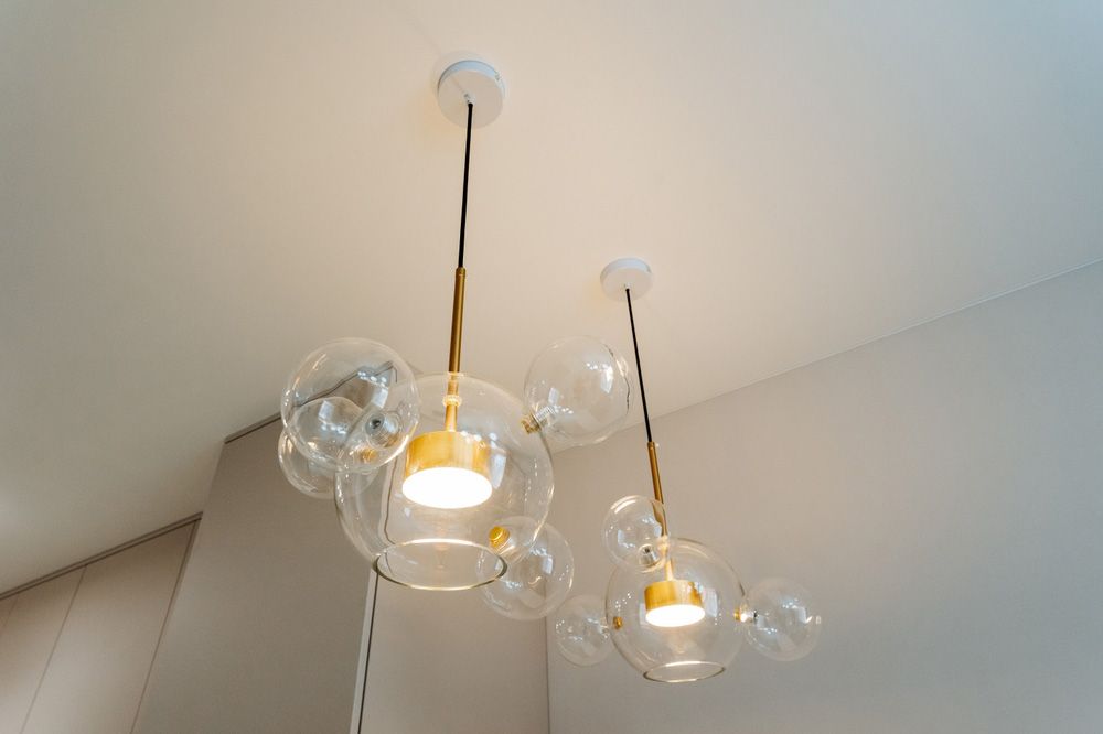A wooden staircase with a glass railing in a house.