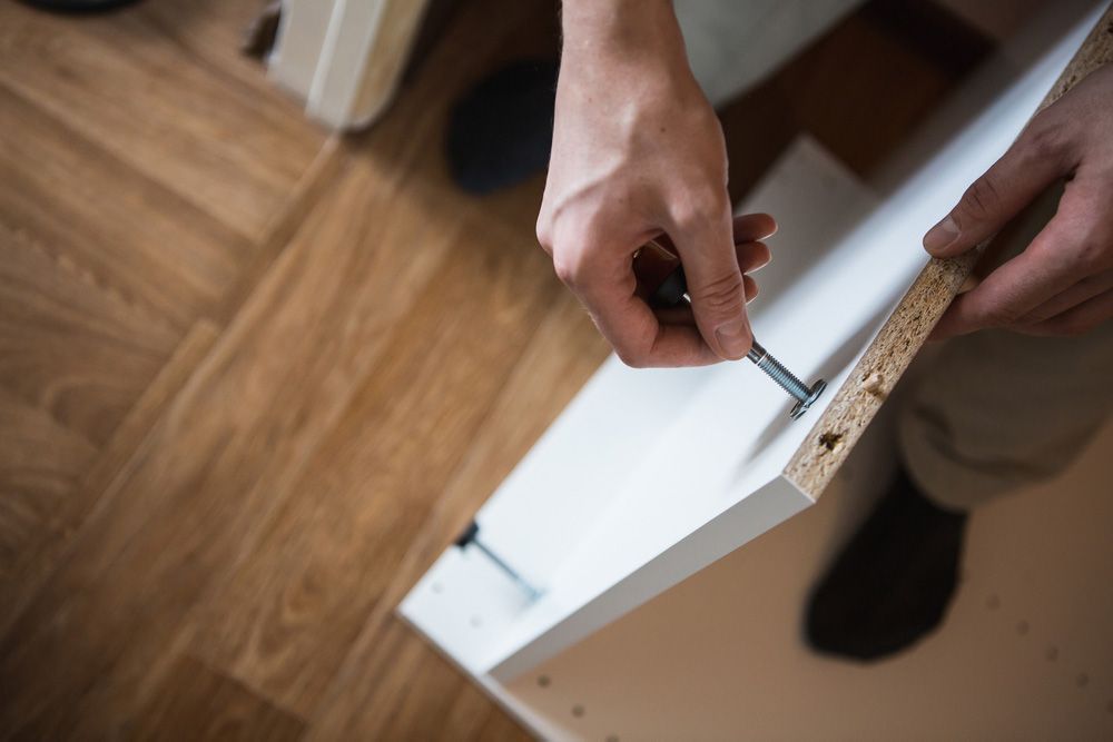 A wooden staircase with a glass railing in a house.
