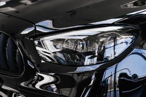 A close up of a black car 's headlight.