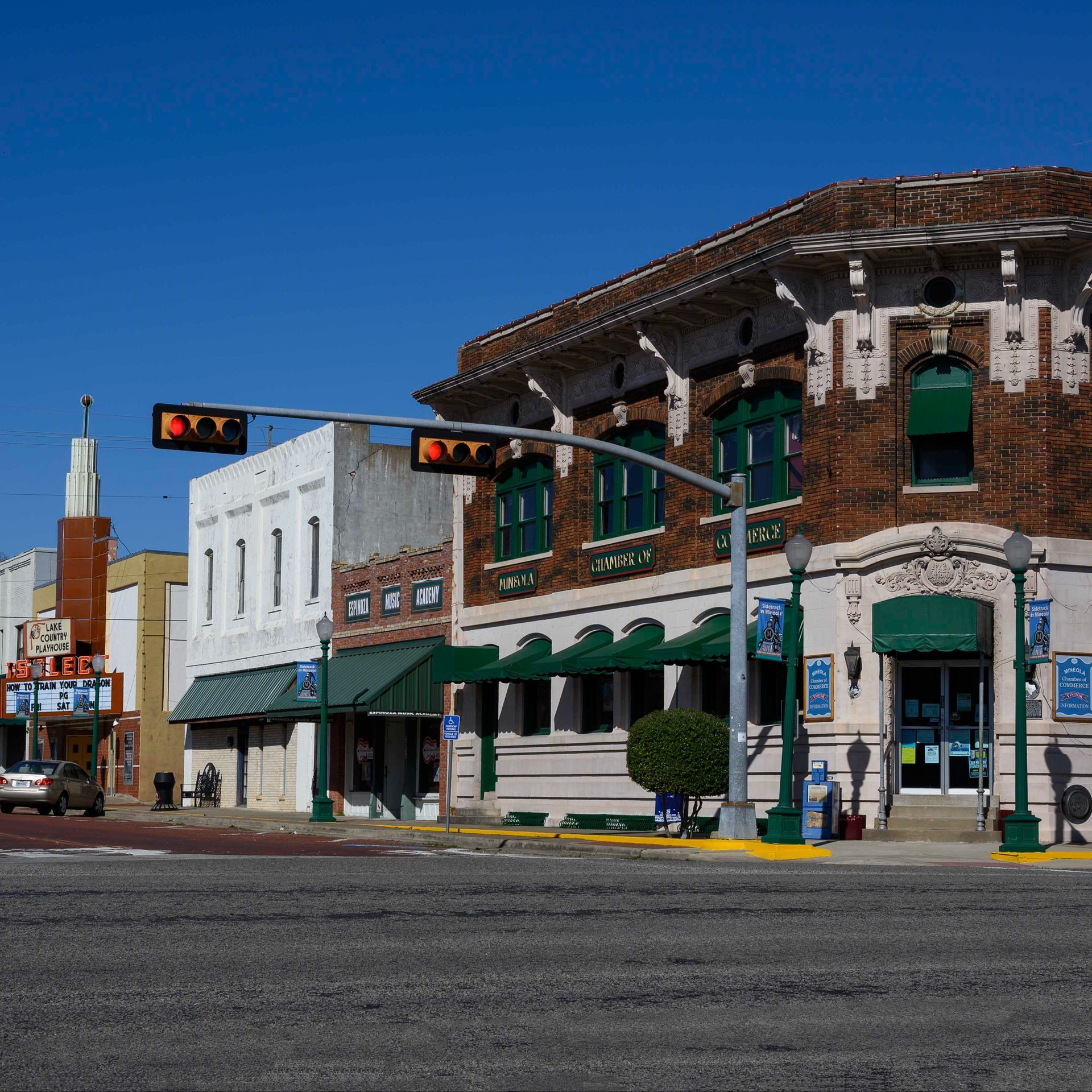 A white van with the number 2151 on the side is parked on the side of the road