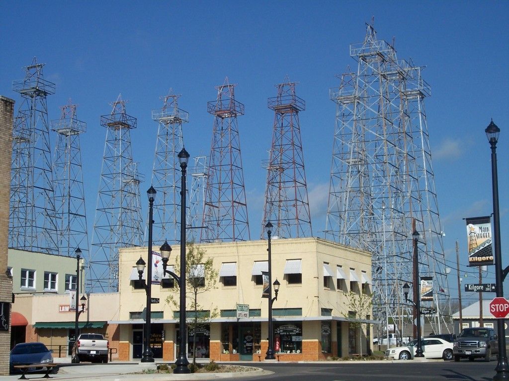 A row of telephone poles are lined up in front of a building