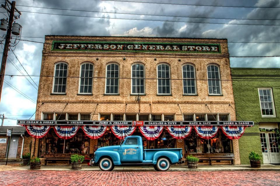 A blue truck is parked in front of the jefferson general store