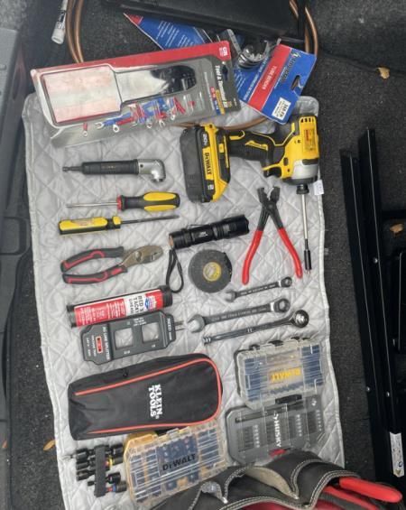 A bunch of tools including a dewalt drill