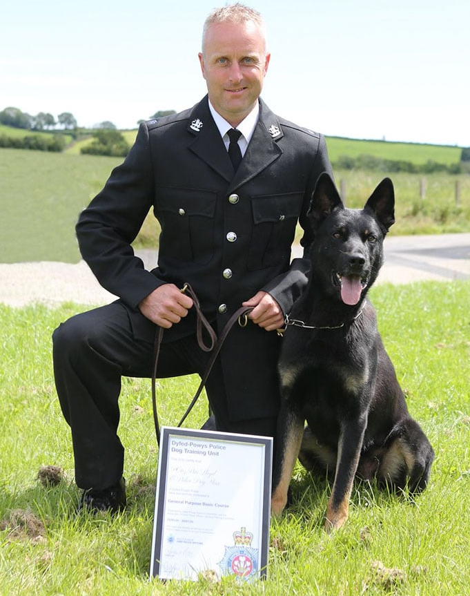 A policeman with a dog