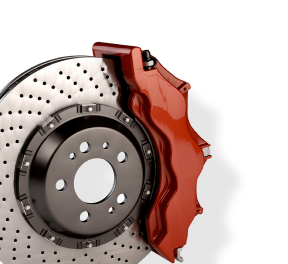Red brake caliper over a drilled brake rotor. | Driver's Choice