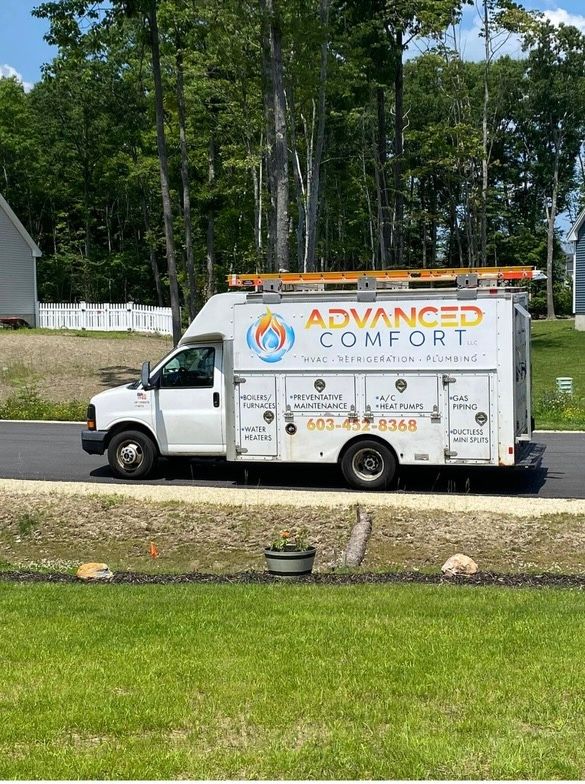 A white advanced comfort truck is parked on the side of the road.