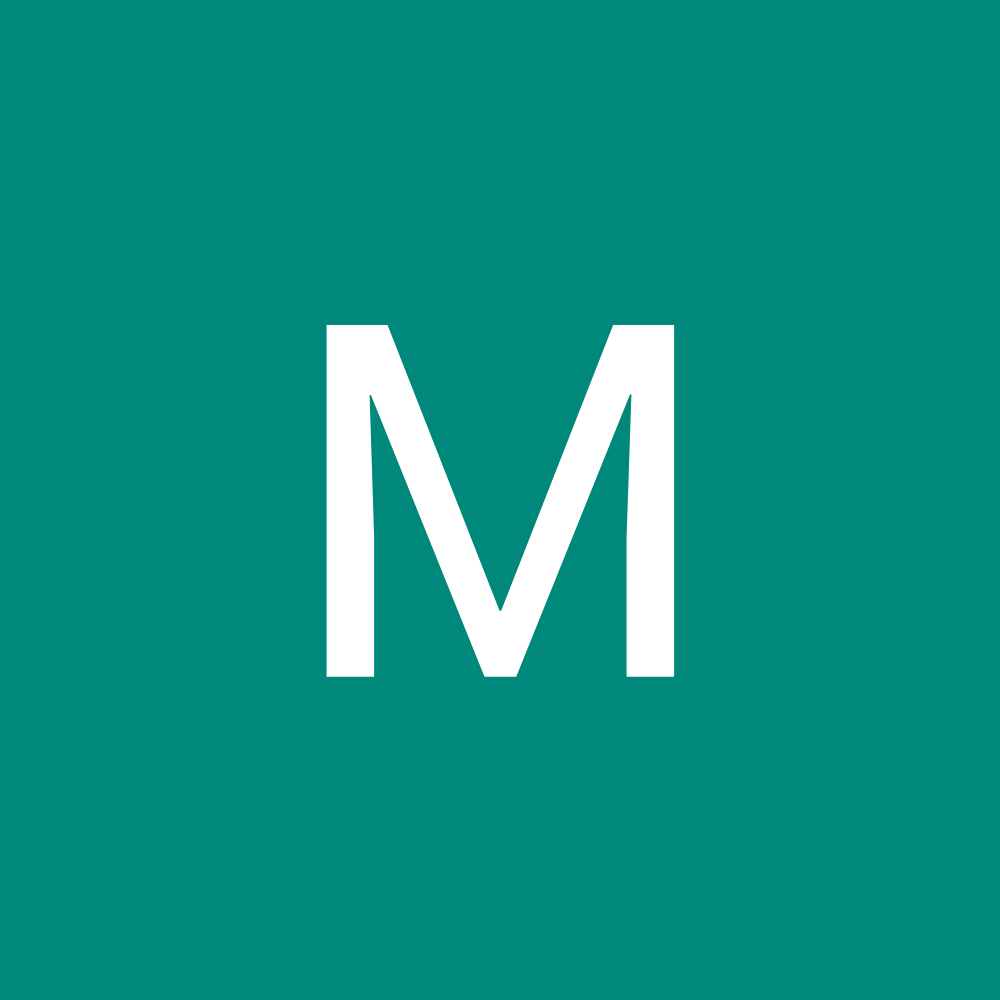 White letter “M” on a teal background.