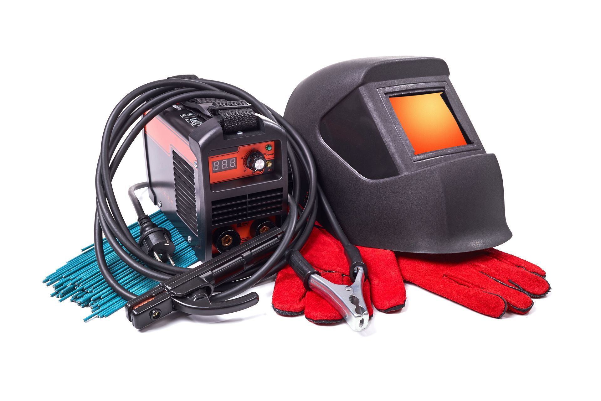 A welding helmet , gloves , and a welding machine on a white background.