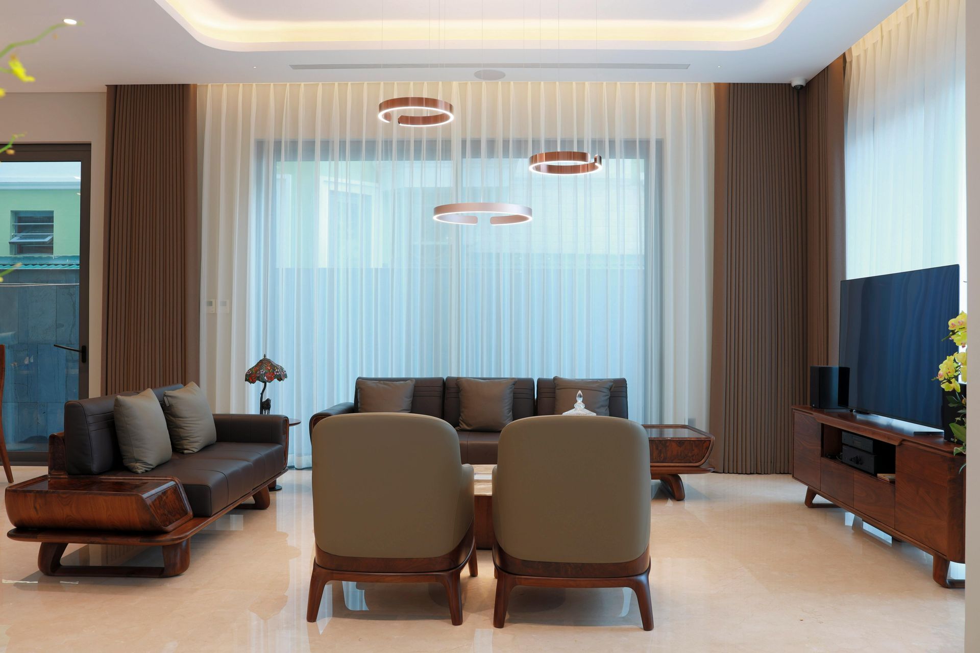 A man in a suit and black shirt is standing in front of a black background.