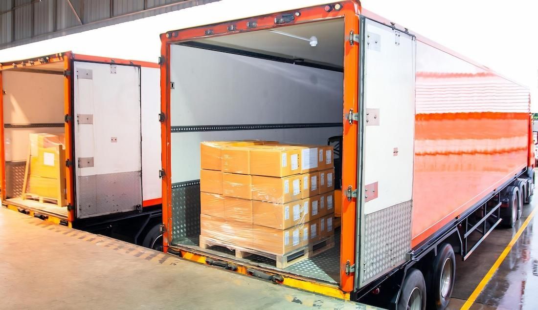 A Truck is Being Loaded With Boxes in a Warehouse — Dunford Removals in Woodgate, QLD