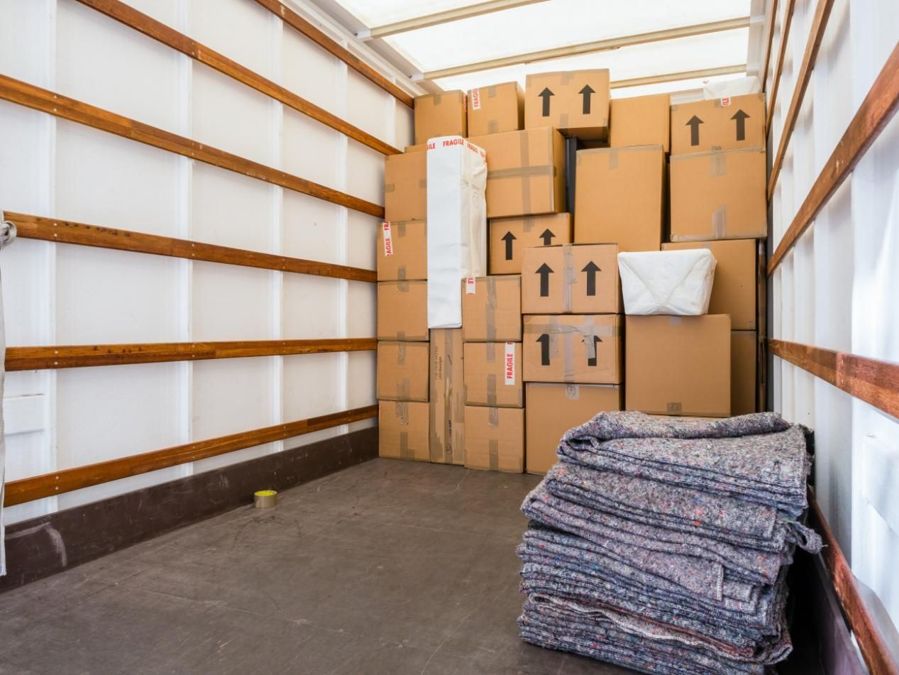 The Inside of A Moving Truck Filled with Boxes and Blankets — Dunford Removals in Agnes Waters, QLD