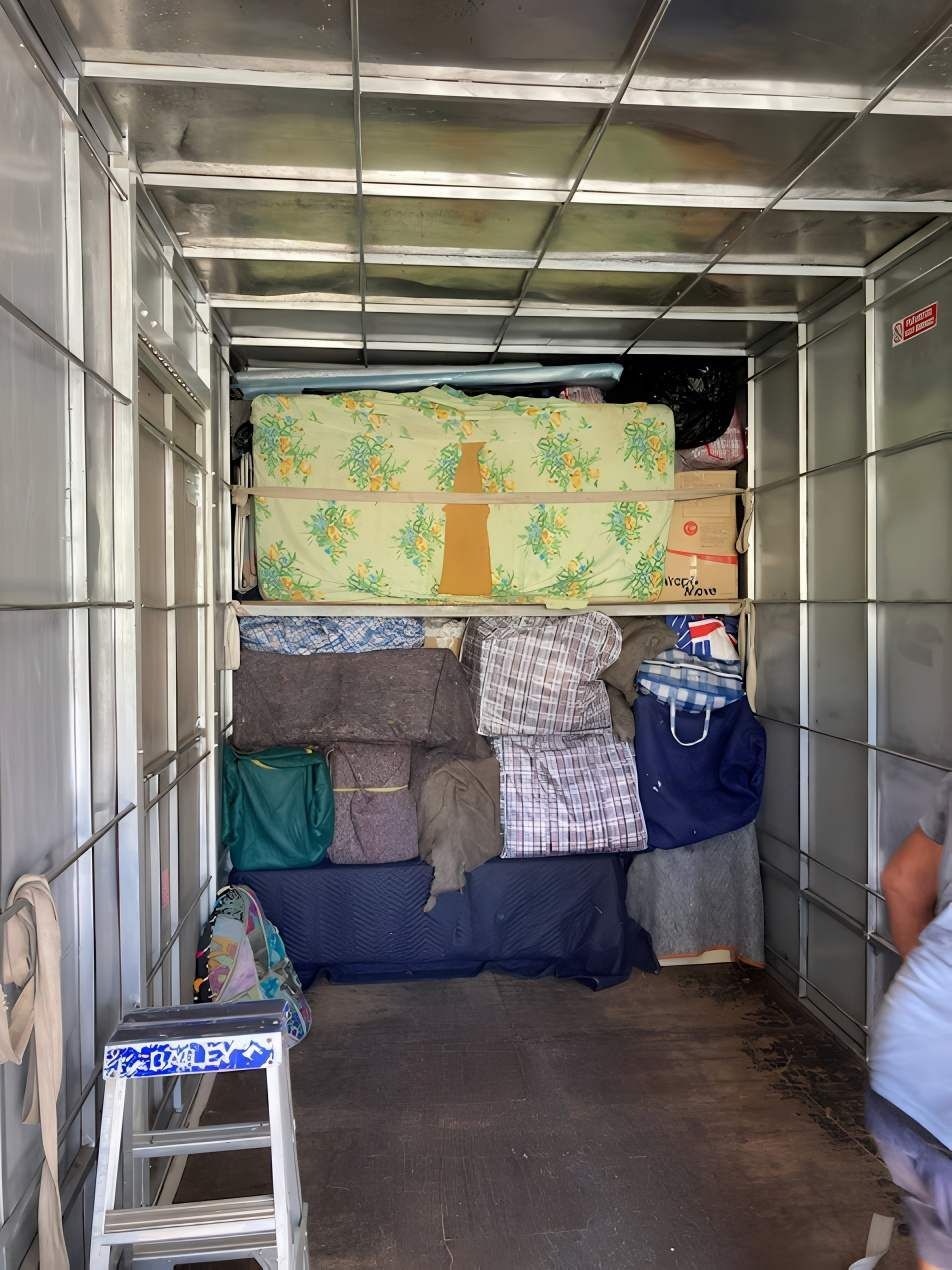 The Inside of a Moving Truck Filled With Lots of Boxes and Mattresses — Dunford Removals in Qunaba, QLD