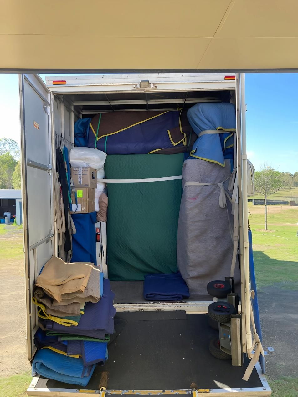 The Back of a Moving Truck Filled With Blankets and Boxes — Dunford Removals in Miriam Vale, QLD