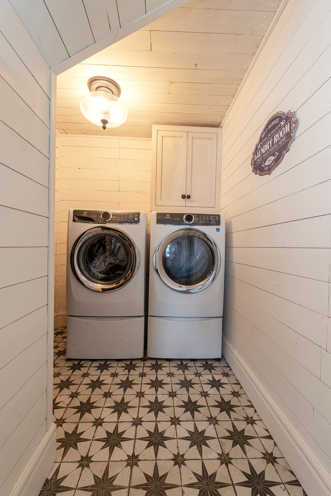 A laundry room with a washer and dryer in it.
