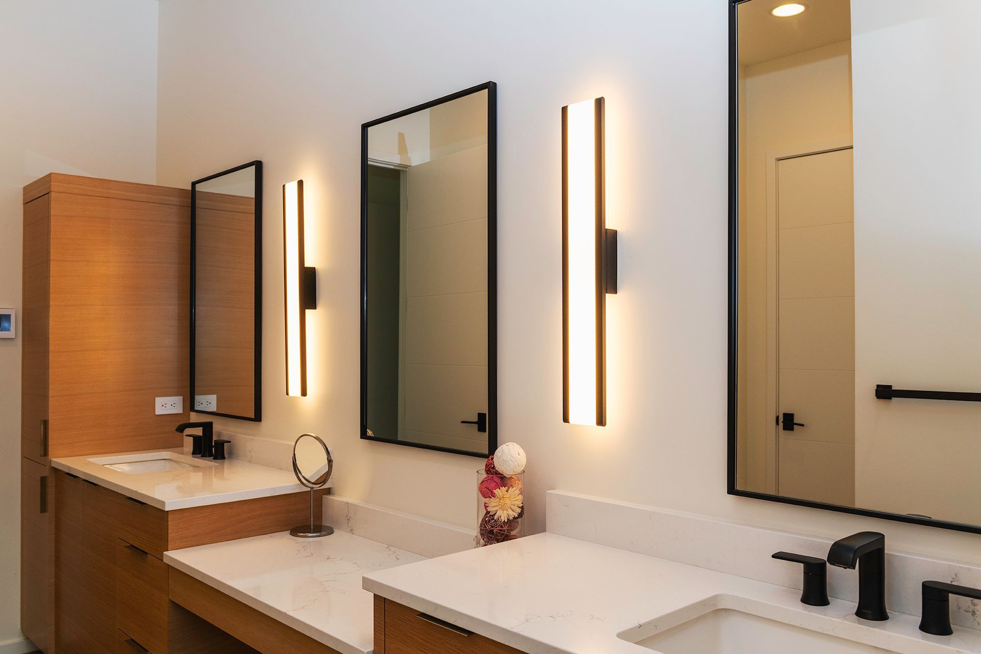 A bathroom with two sinks and two mirrors.