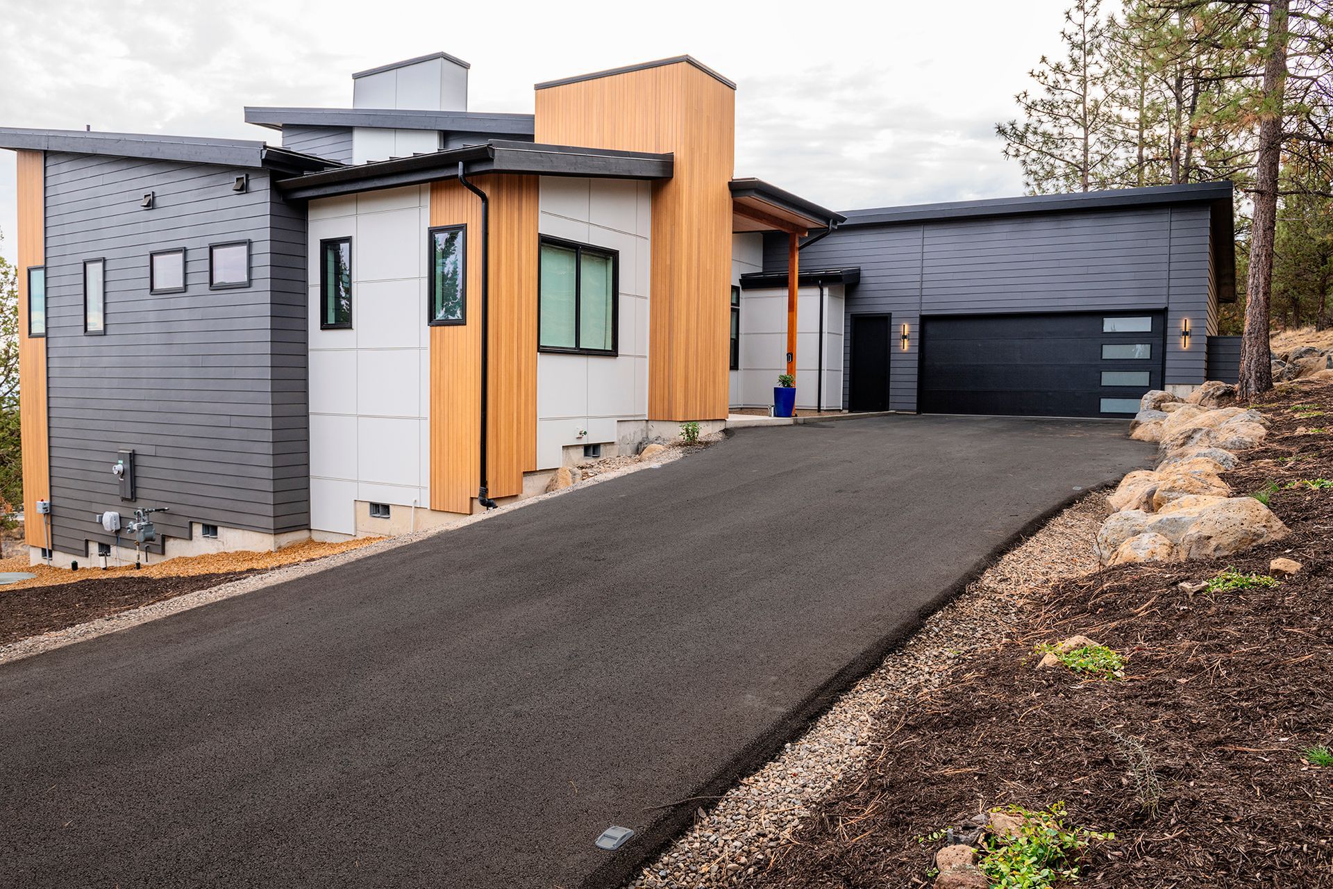 A modern house with a driveway leading to it and a garage.