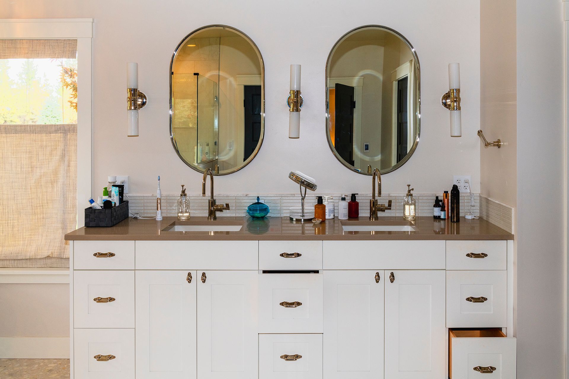 A bathroom with two sinks and two mirrors.