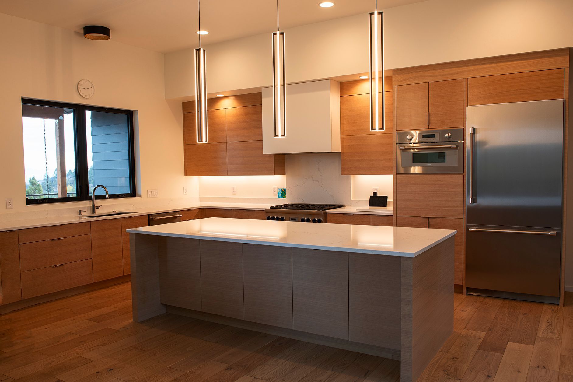 A kitchen with a large island and stainless steel appliances