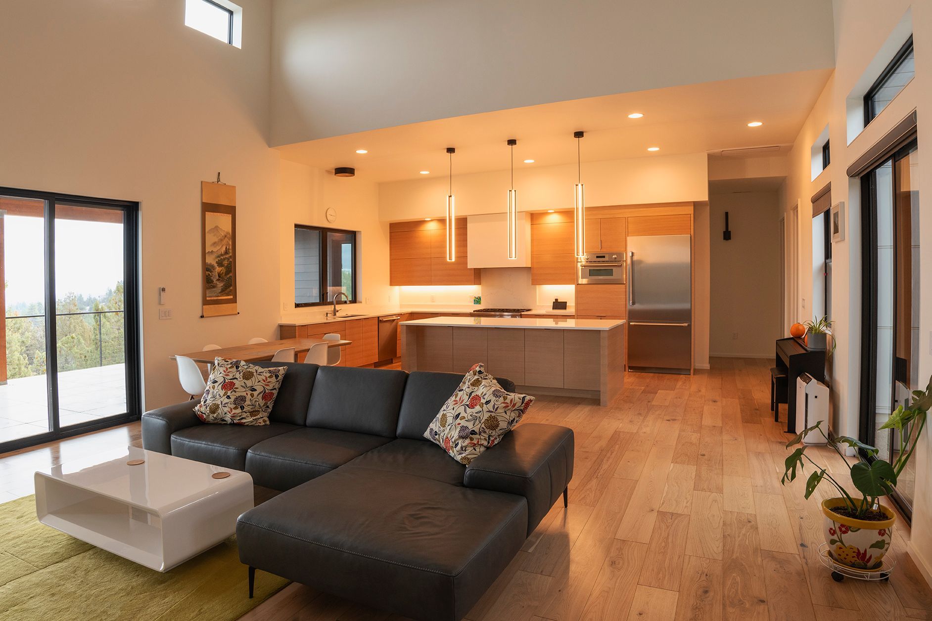A living room with a couch , coffee table , and kitchen.