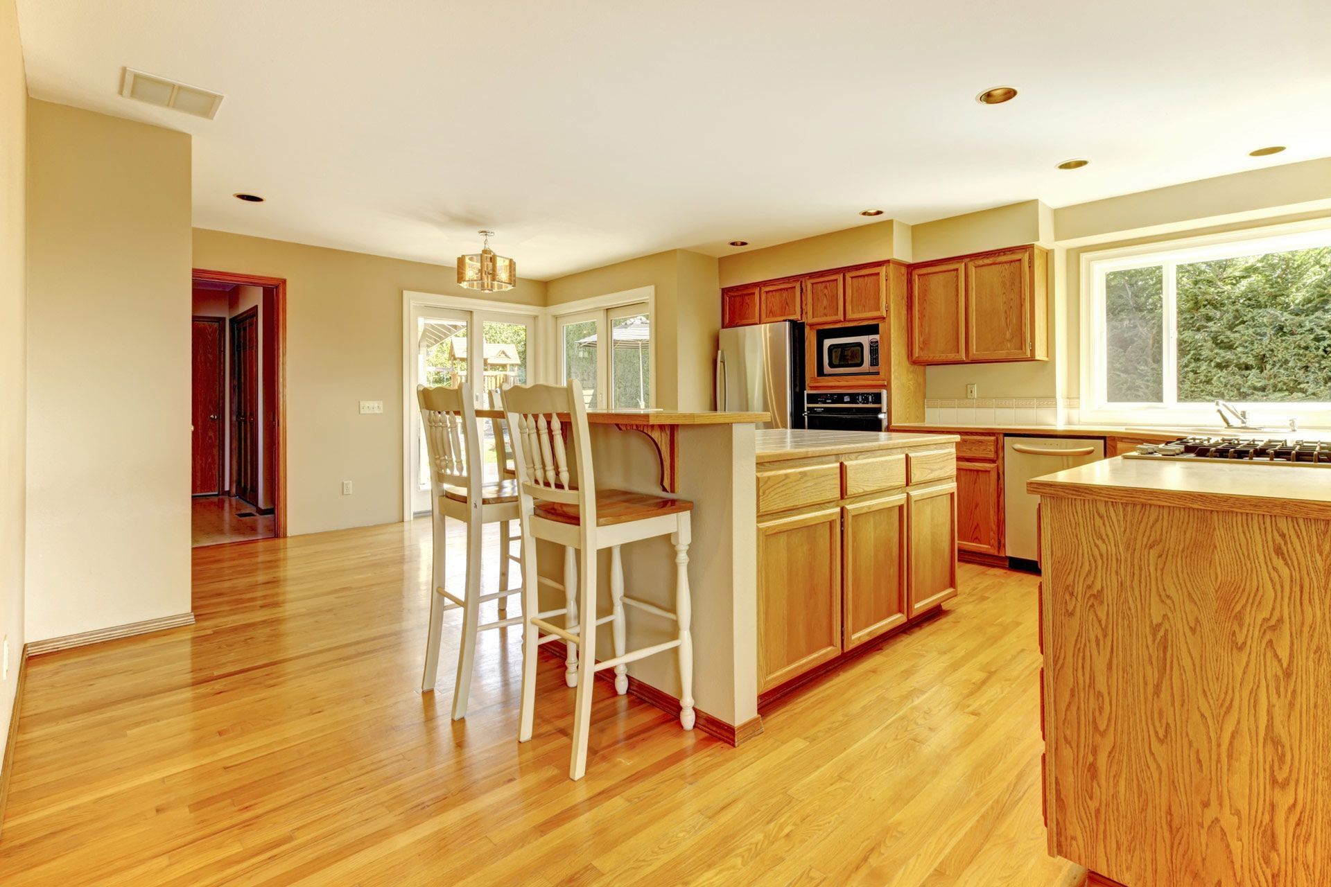 A kitchen with hardwood floors and wooden cabinets — Bend, OR — Ross Built Custom Homes