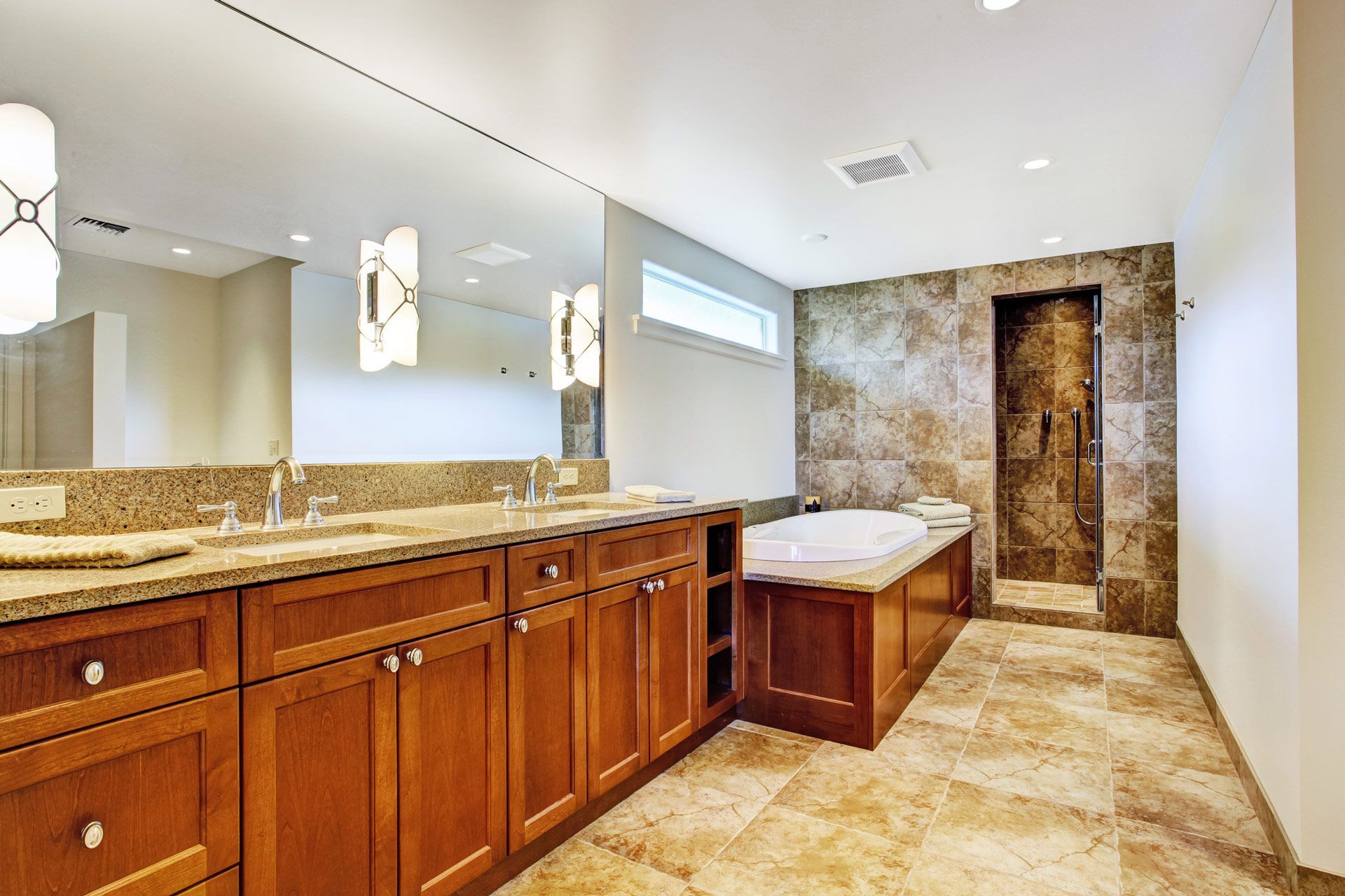 A bathroom with two sinks and a large mirror — Bend, OR — Ross Built Custom Homes