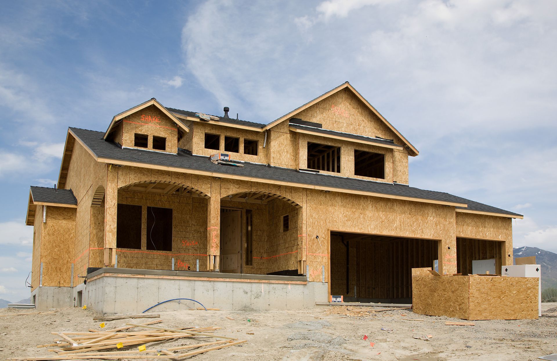 New house under construction with wooden framework.