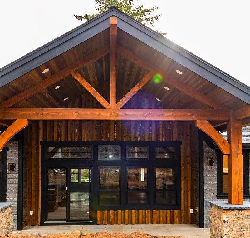 A house with a wooden roof and black windows