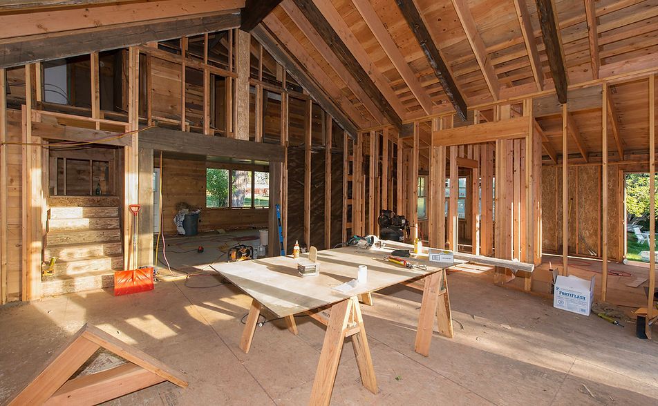 A house is being built with wooden beams and a table in the middle of the room