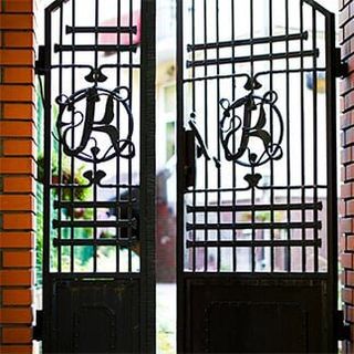 Black wrought iron and brick entrance gates — window guards in Torrance, CA
