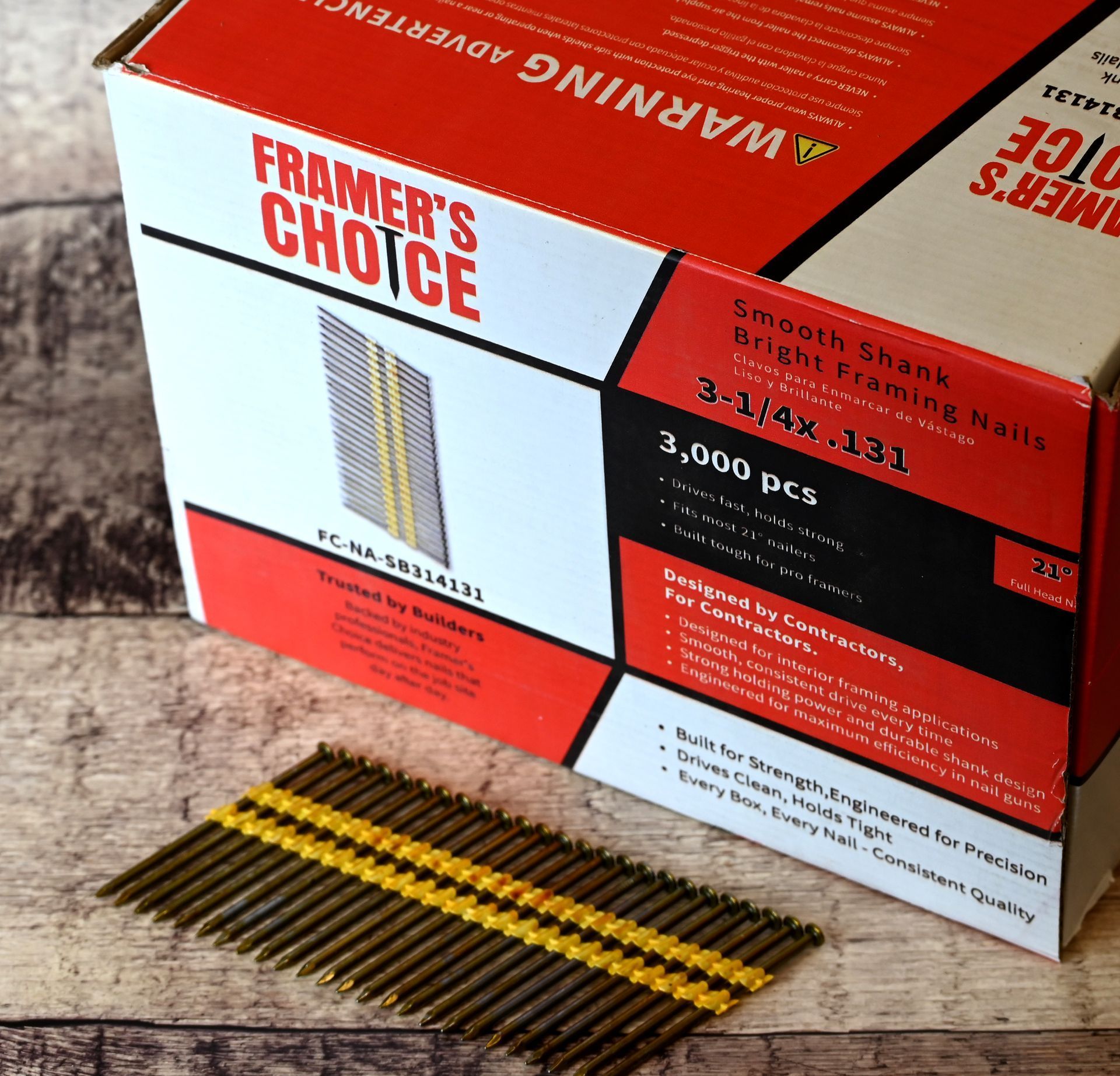 Box of Framer's Choice common nails with loose nails on a wooden surface