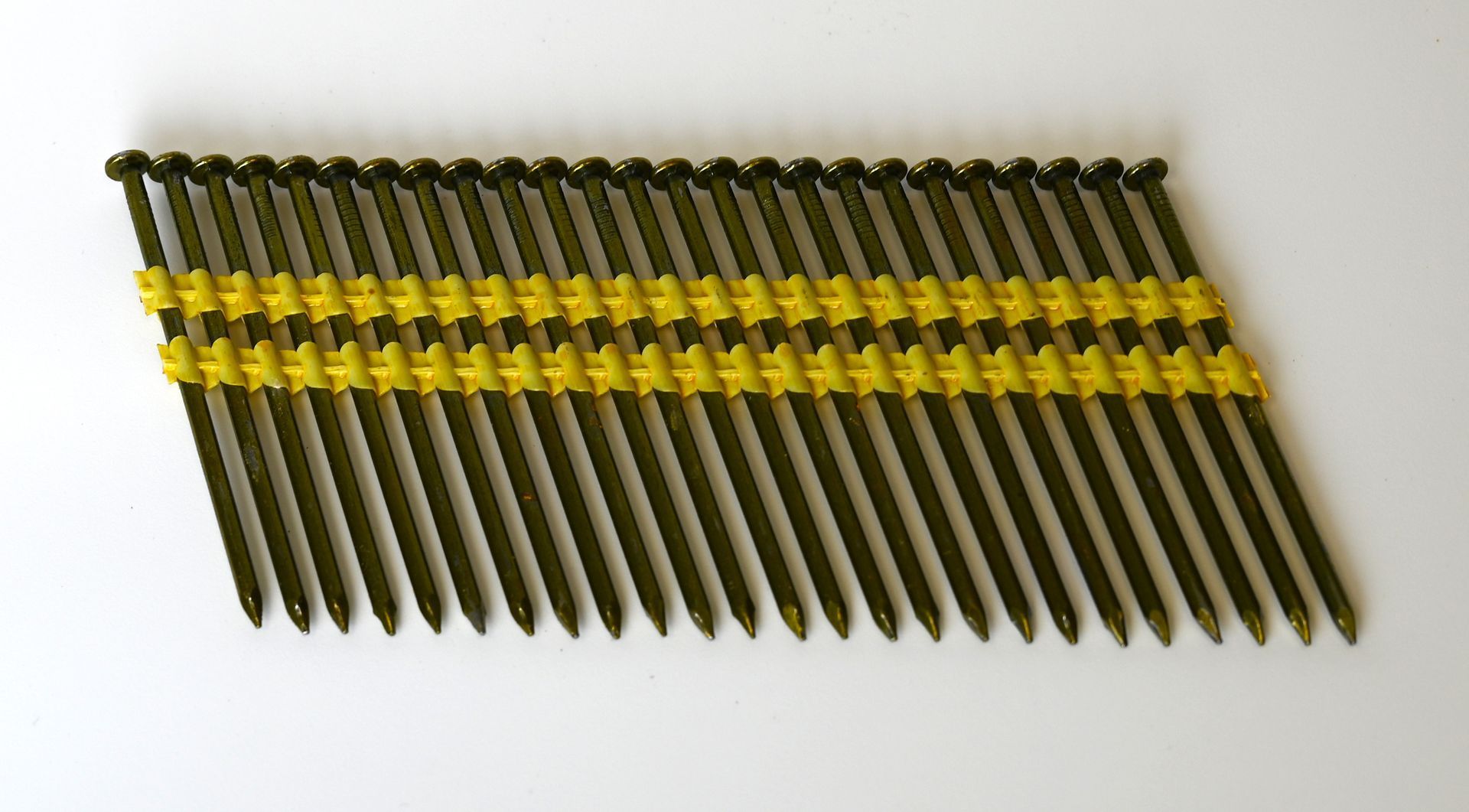 Box of Framer's Choice common nails with loose nails on a wooden surface