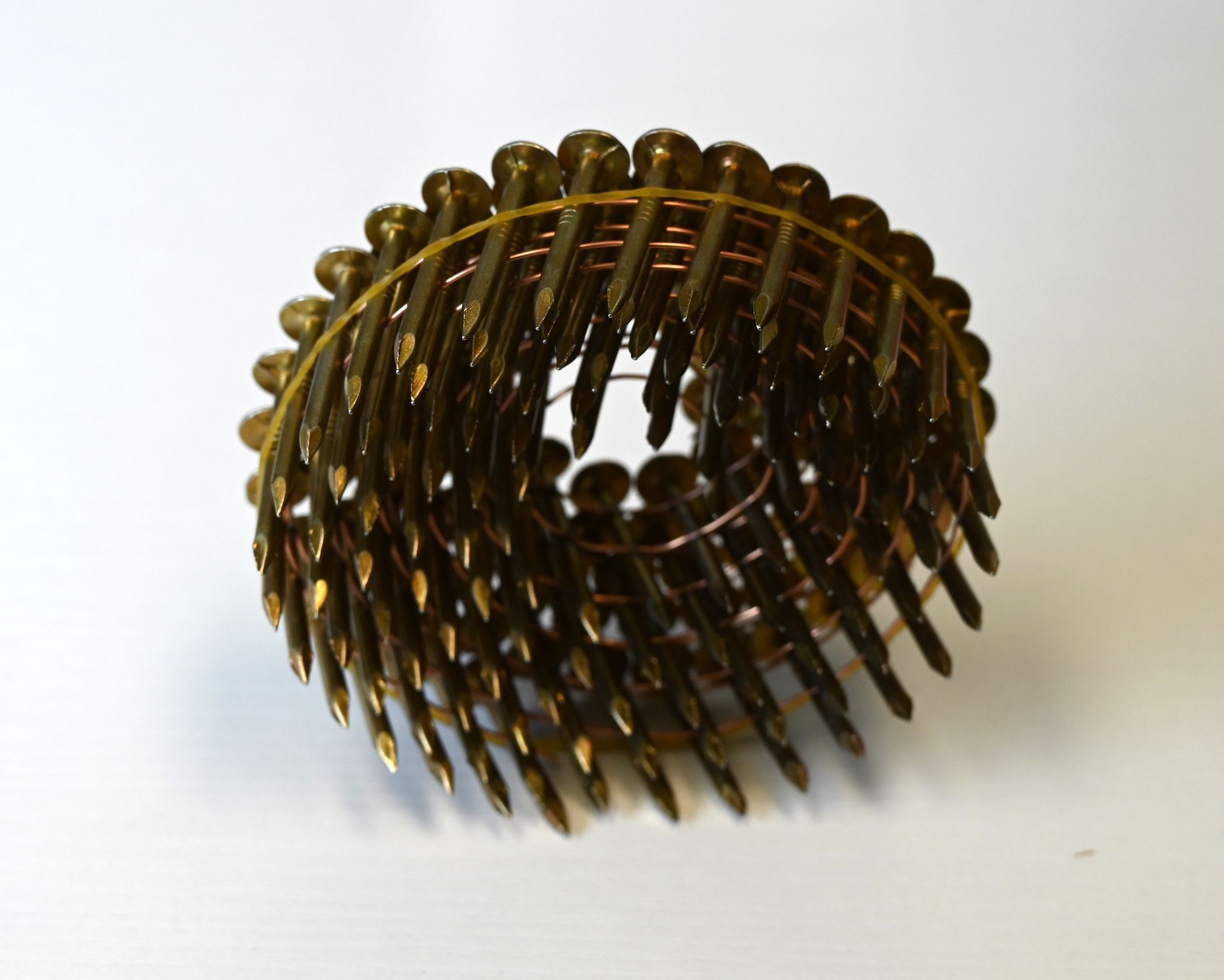 Work gloves beside a box labeled “Framer’s Choice” and a spiked metal wheel tool