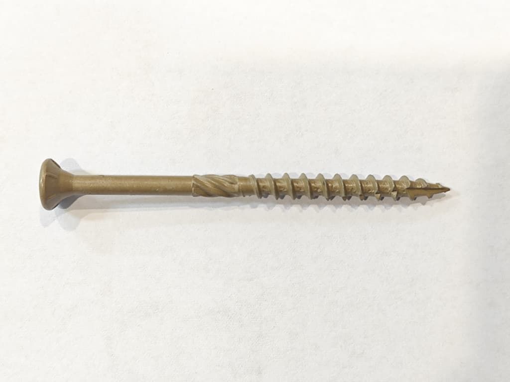 Single metal wood screw with a flat, countersunk head on a light background