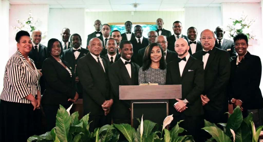 A group of people are posing for a picture in front of a podium.