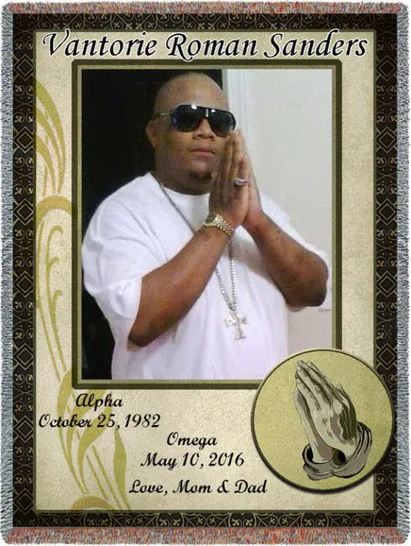 A picture of vantore roman sanders with his hands folded in prayer