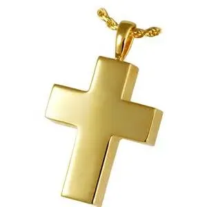 A gold cross pendant on a chain on a white background.