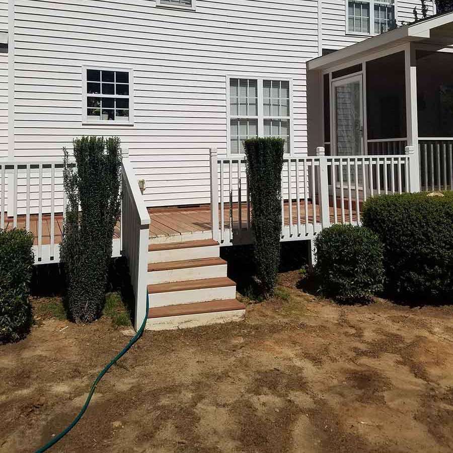 Backyard deck with steps and white railing