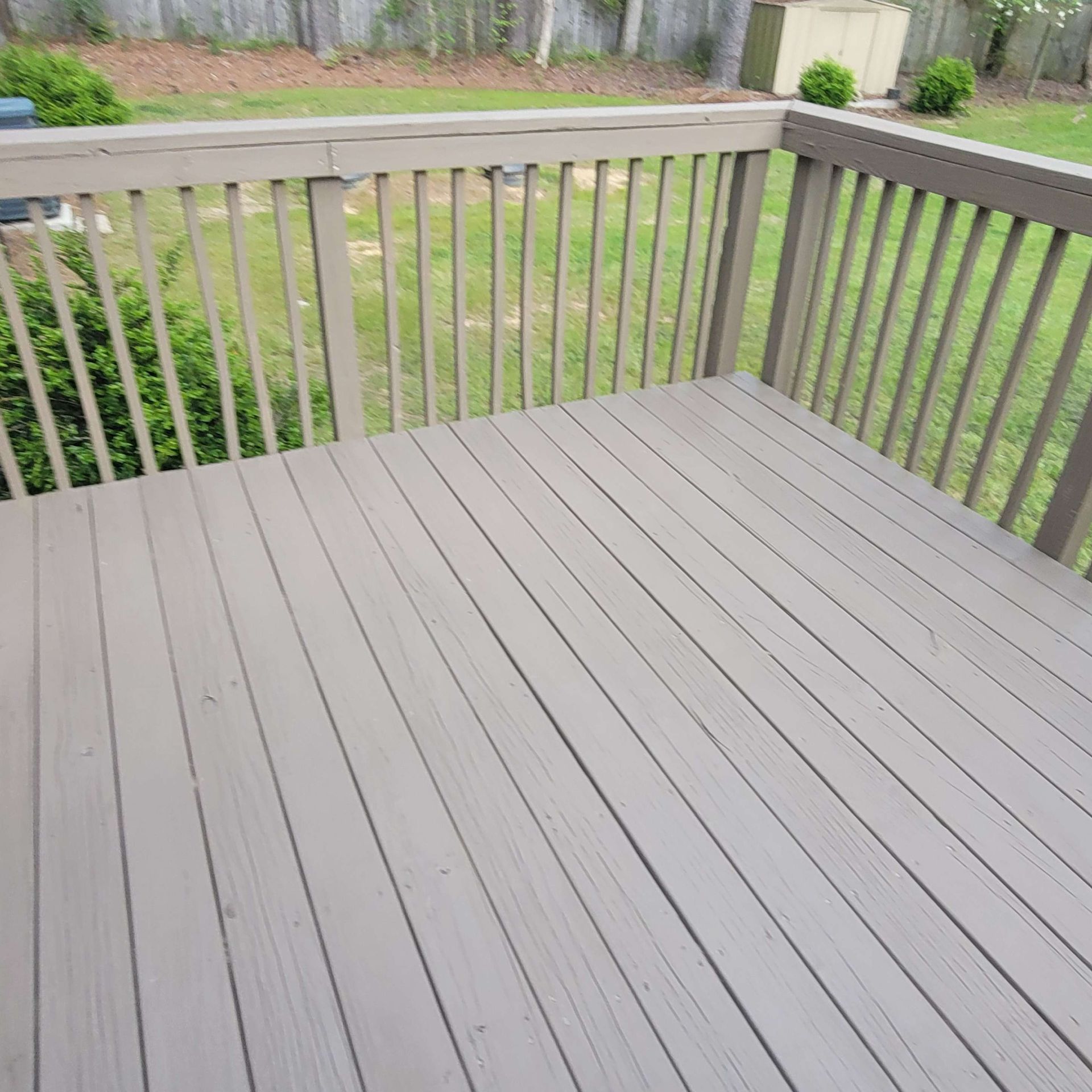 Wooden deck with railing, painted light gray