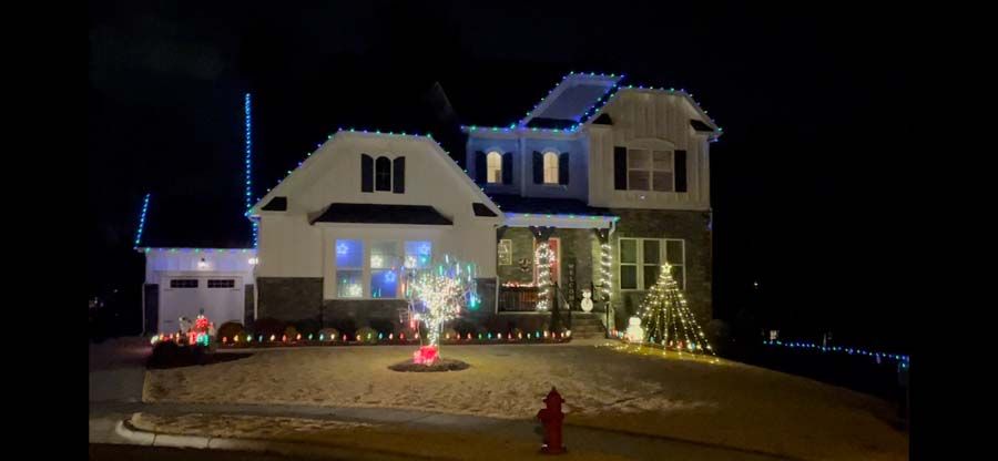 A house decorated with Christmas lights at night.